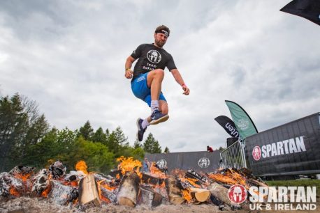man jumping over fire at Spartan Race UK